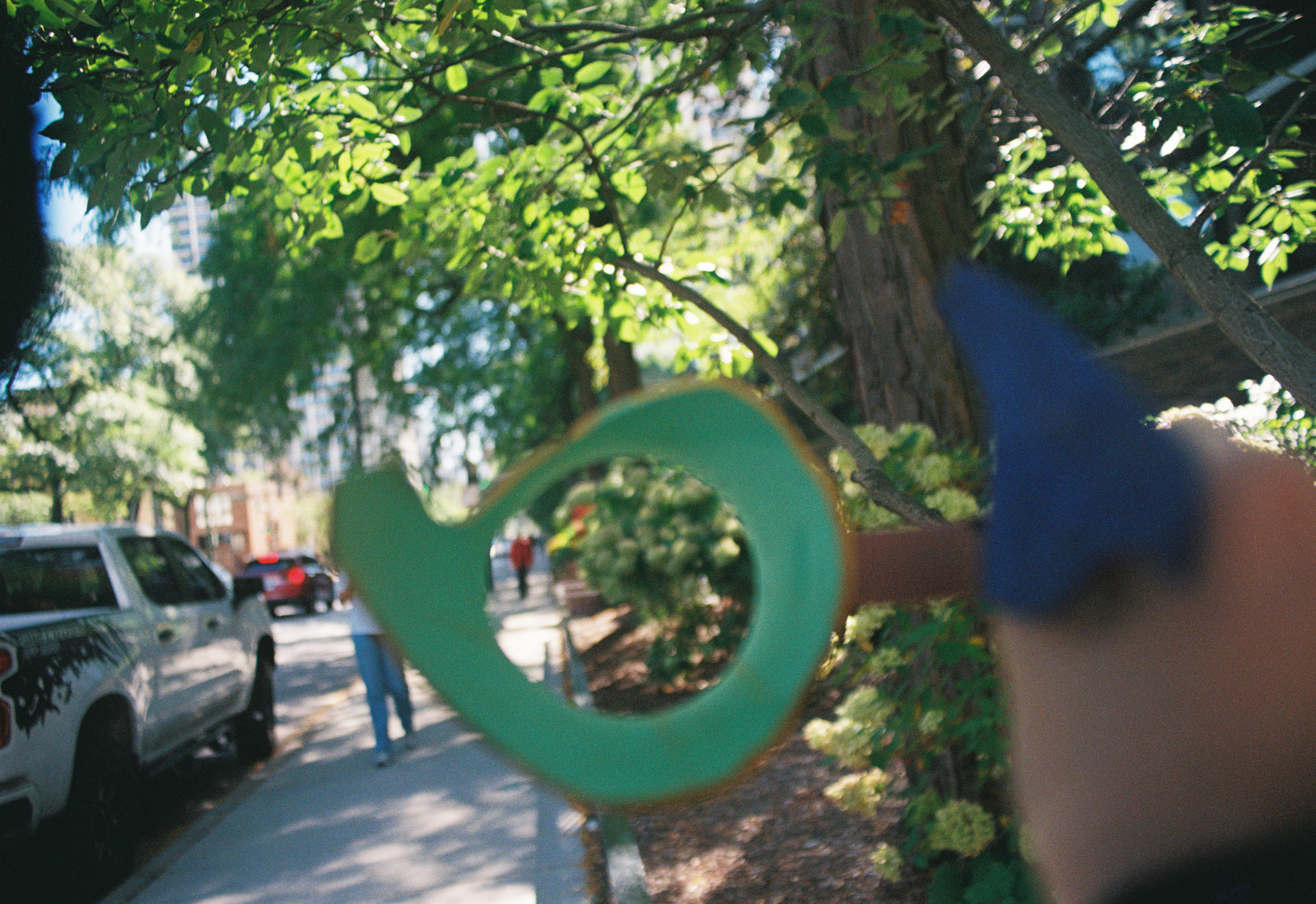 photograph of the author holding a broken water jug she painted for art